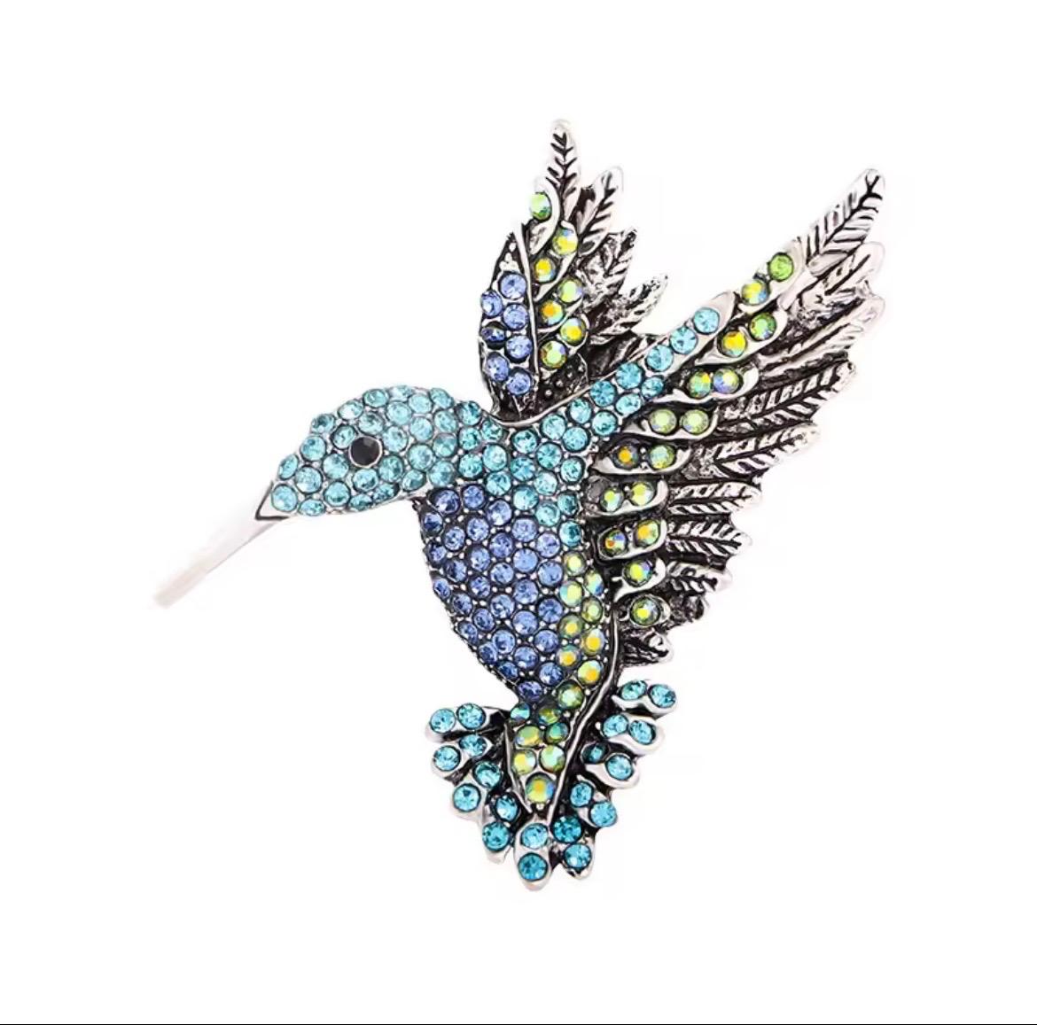 Broche met blauwe vogel