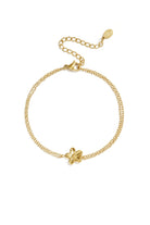 Goudkleurige dubbele minimalistische armband met een hanger in de vorm van een bloem
